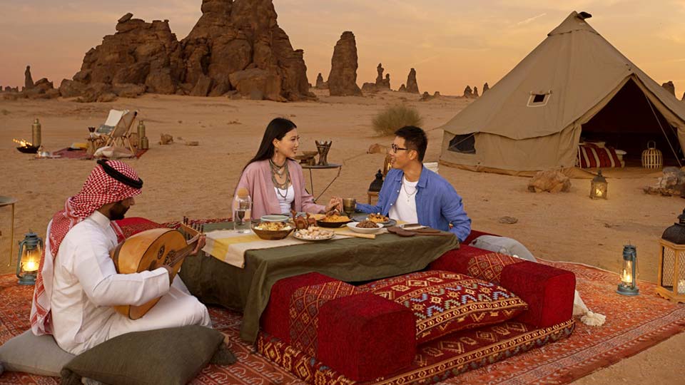 A couple having dinner in Gharameel of Al Ula at sunset source, visitsaudi