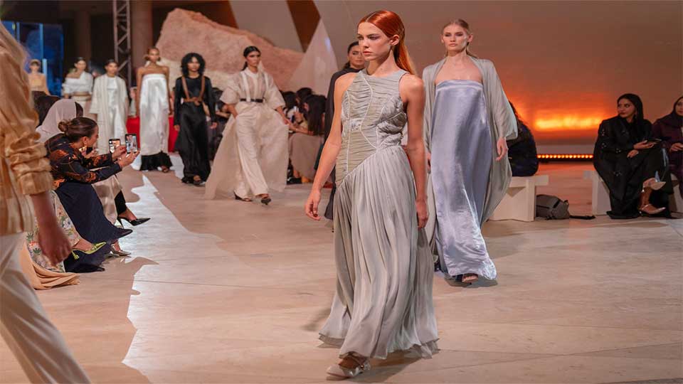 Models walking the winding runway in monochromatic looks.