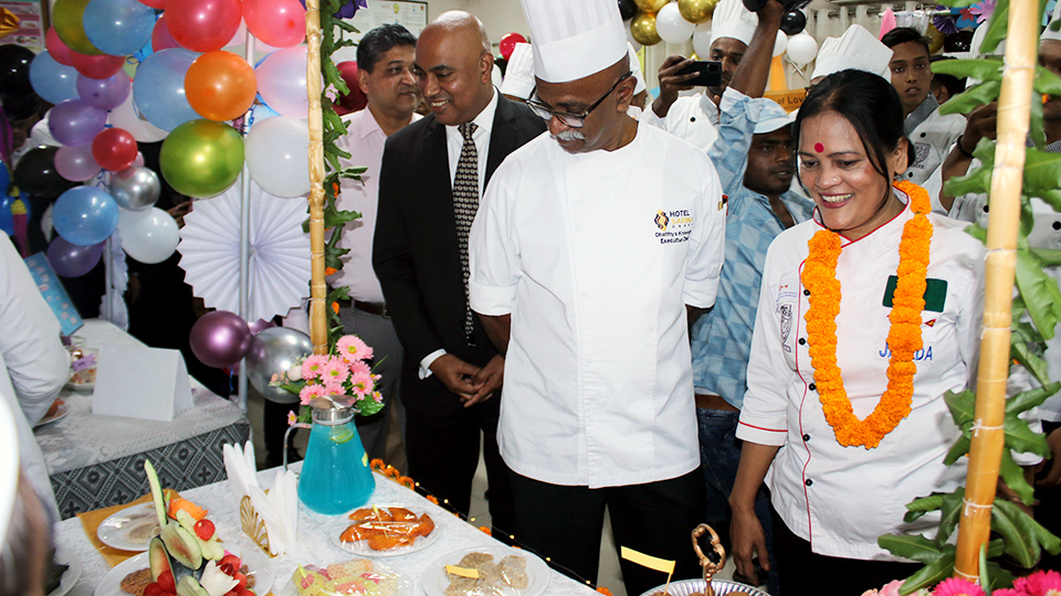 Participants of the NHTTI’s culinary contest demonstrating various food items to guests